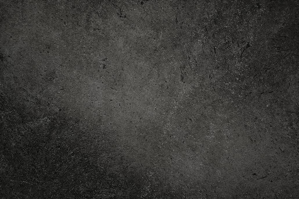 Hartbetonbelag der Mion AG — dunkle, atmosphärische Beton-Oberfläche